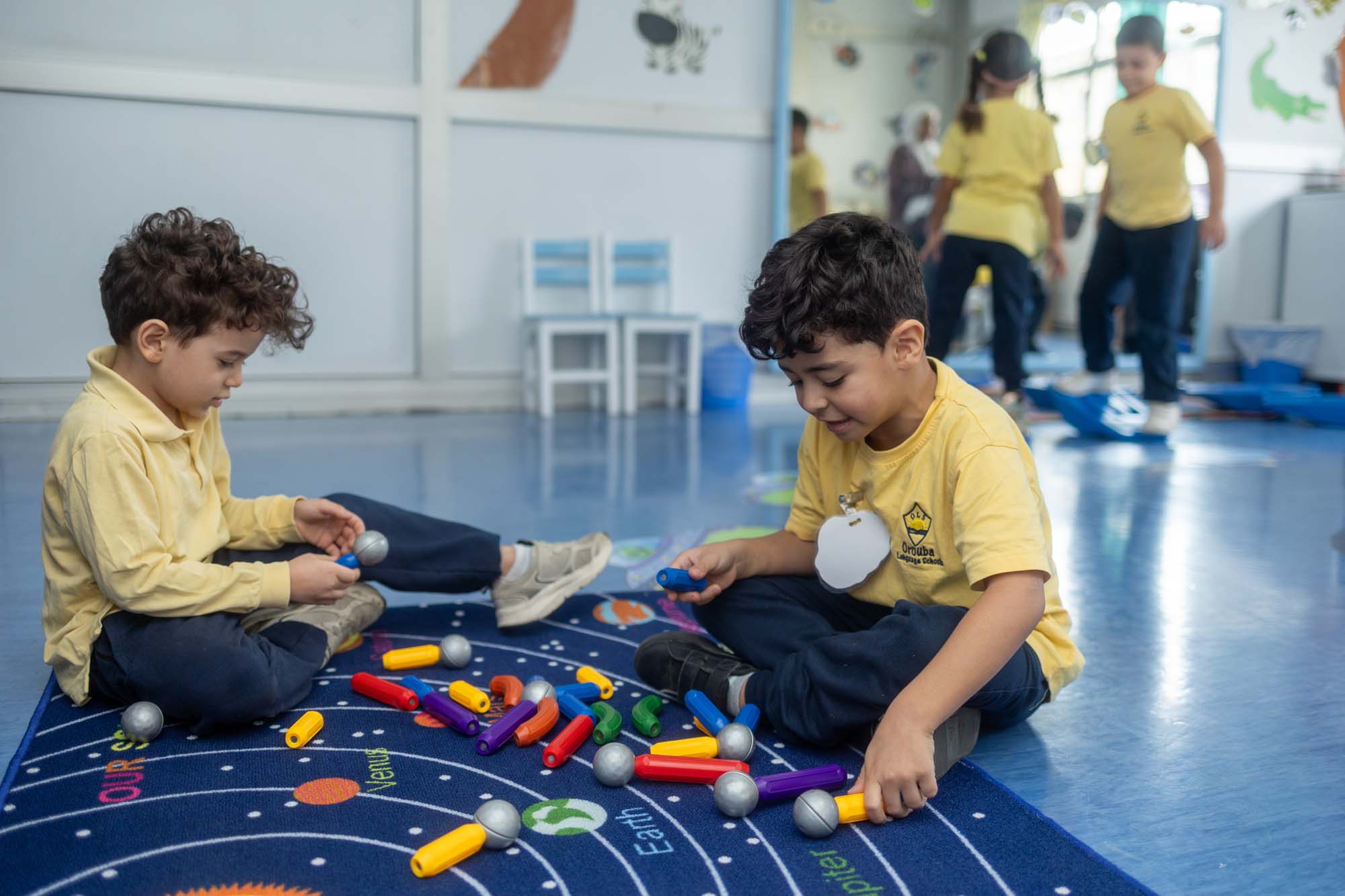 Kindergarten children exploring magnetic construction toys together