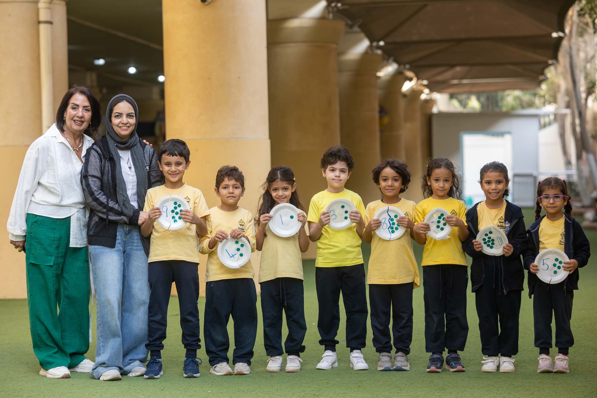 Kindergarten children with their teachers and completed creative work