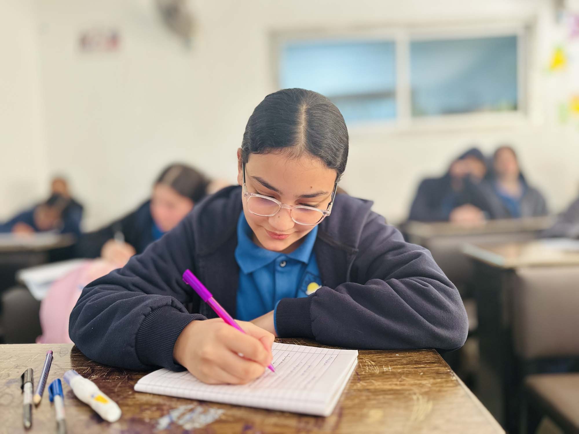 A preparatory student concentrating on written work
