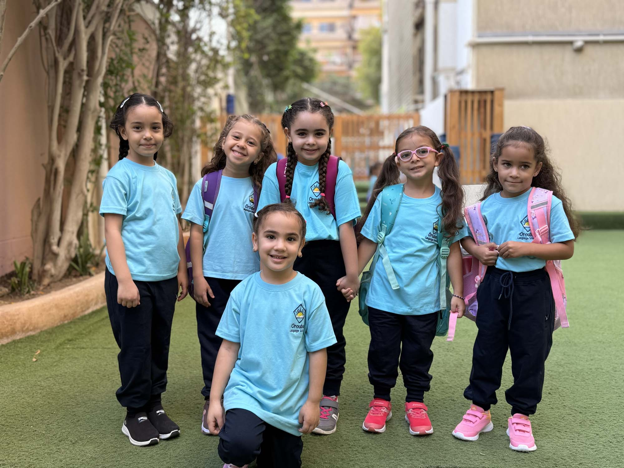Kindergarten classmates standing together outdoors at OLS