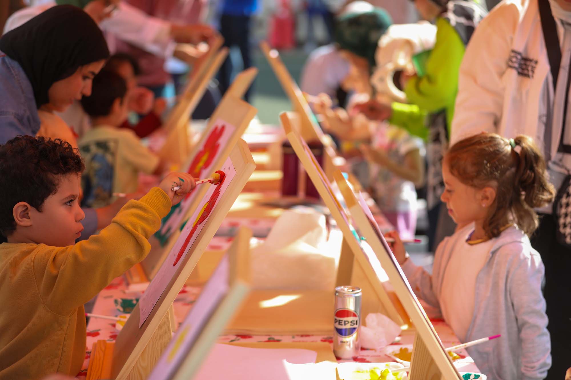 OLS children painting together at easels during the colour festival