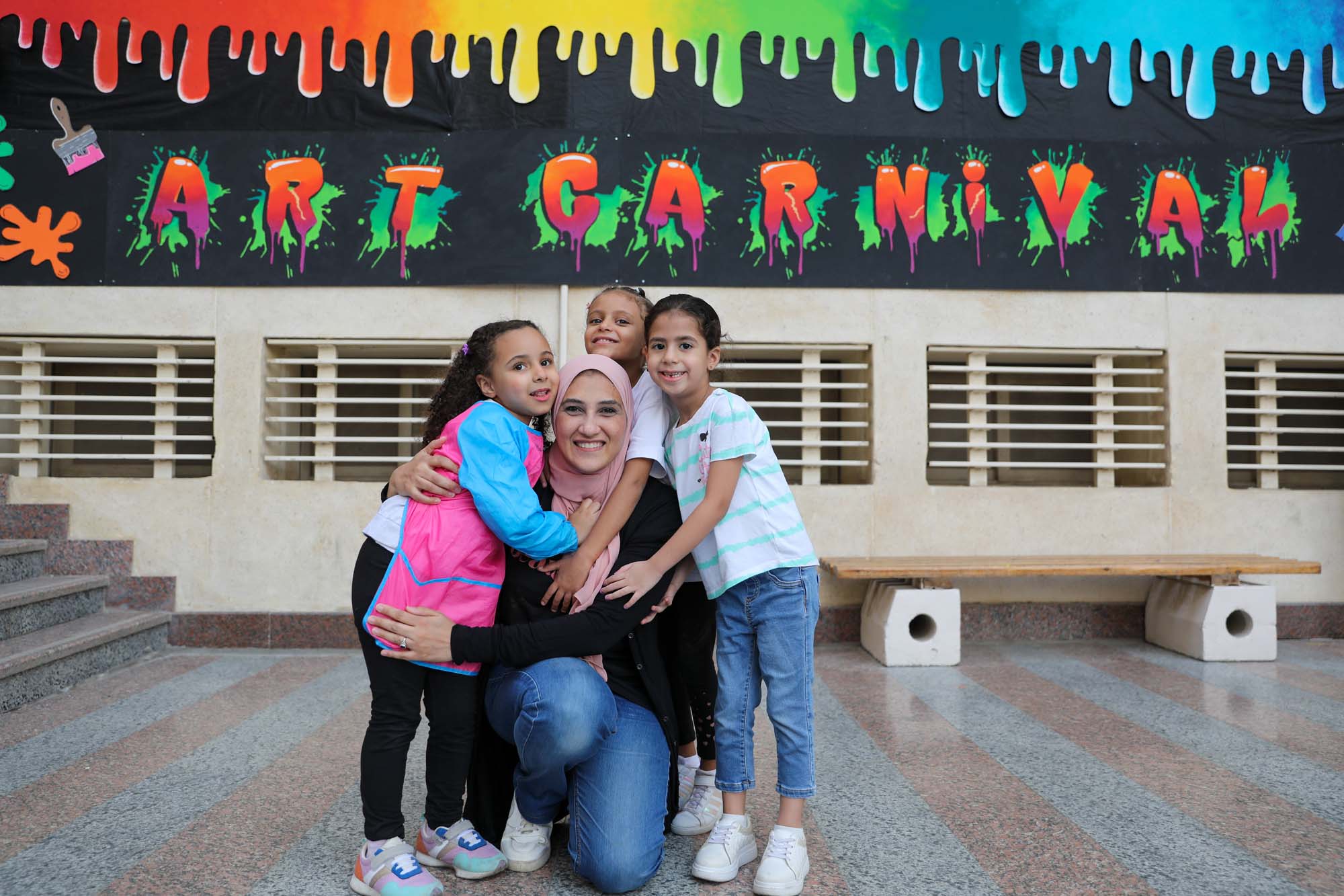 Children and an adult together at the OLS art carnival
