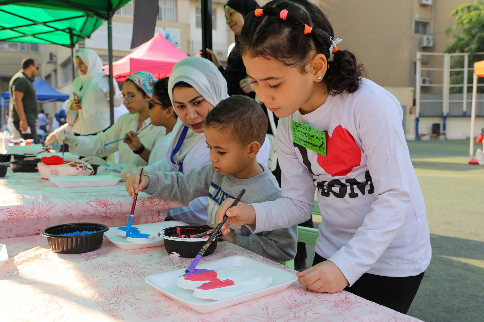 Primary pupils painting at an outdoor OLS art workshop