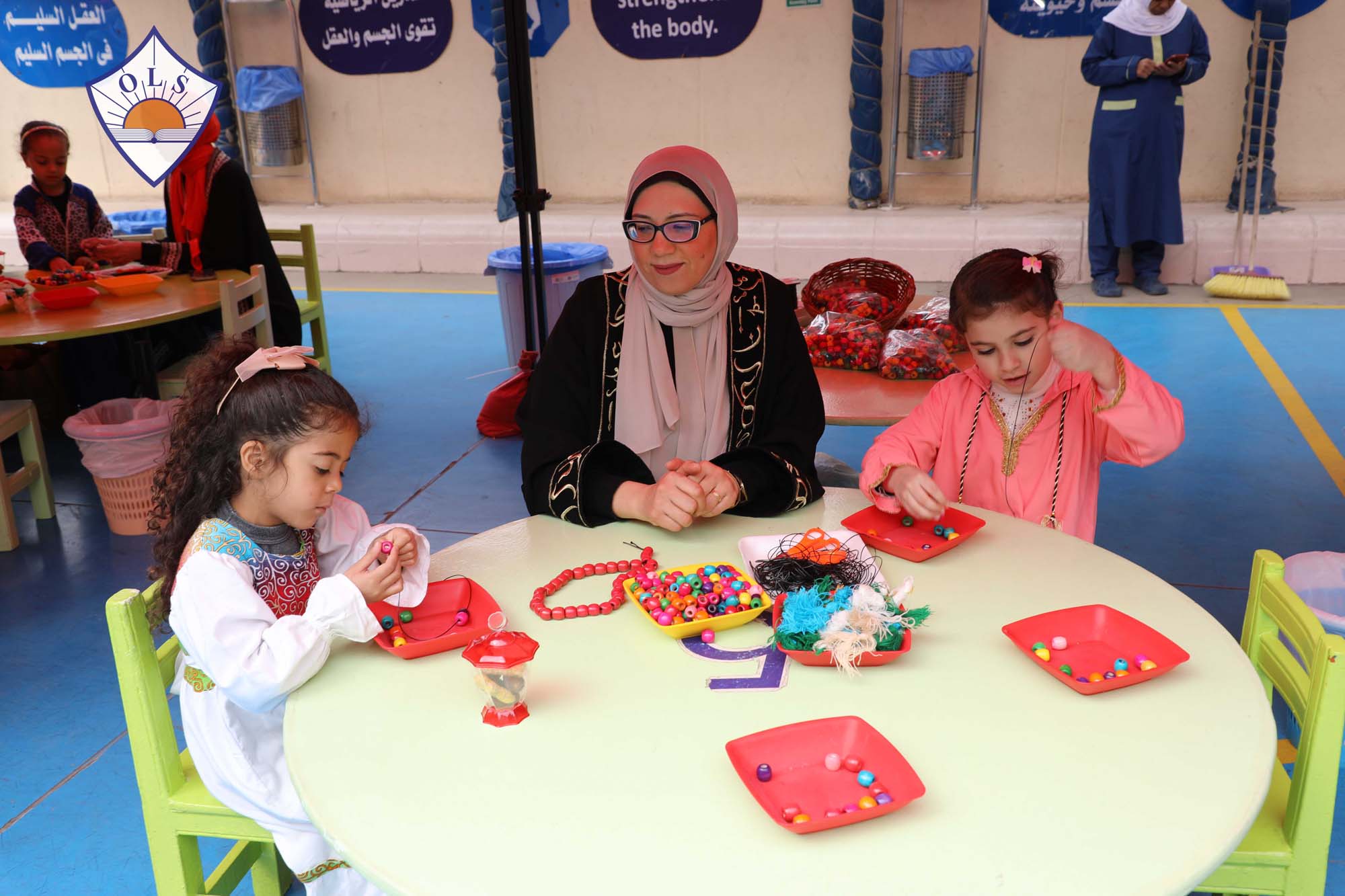 Children and adults making crafts together at an OLS Ramadan activity